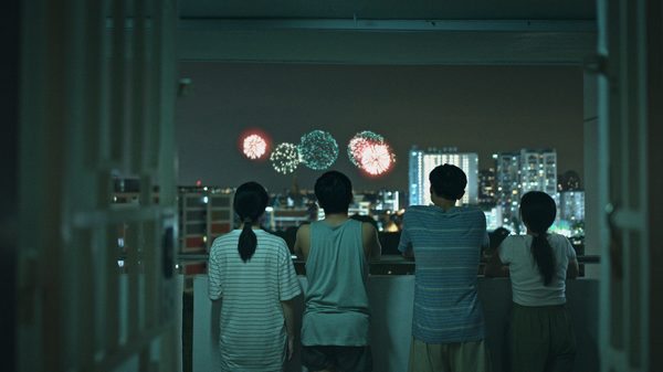 We Are All Strangers film image; people watching fireworks through a window