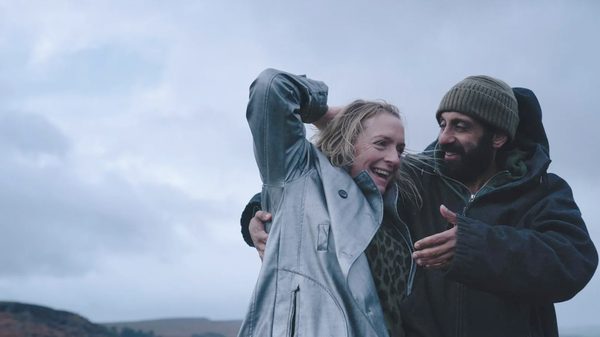 Ali & Ava film image; two people clutching each other and laughing joyously