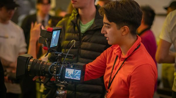 person filming with a movie camera