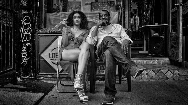 Kensington Market film image; two people sitting in chairs outside
