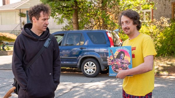 Love and Money film image; two men standing in a street