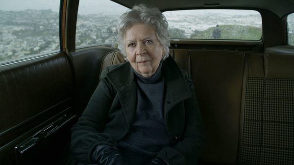 Suburban Fury film image; woman sitting in the back of a car