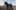Amrum film image; three people leading a horse through a barren field