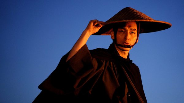Bushido film image; man looking down at something