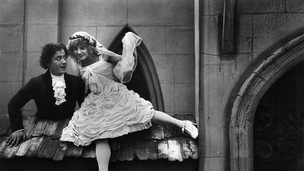 The Doll film image; woman leaning against a seated man