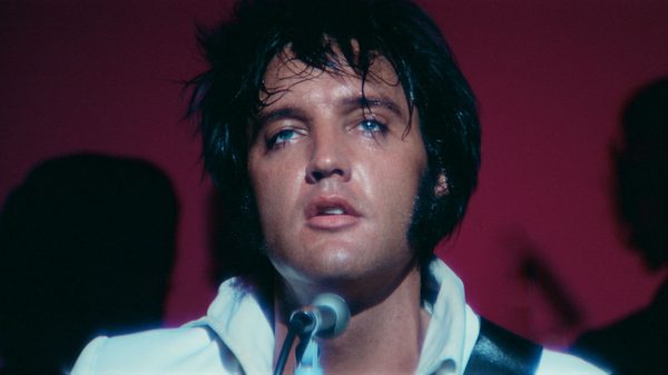 EPiC: Elvis Presley in Concert film image; close on man singing into a microphone