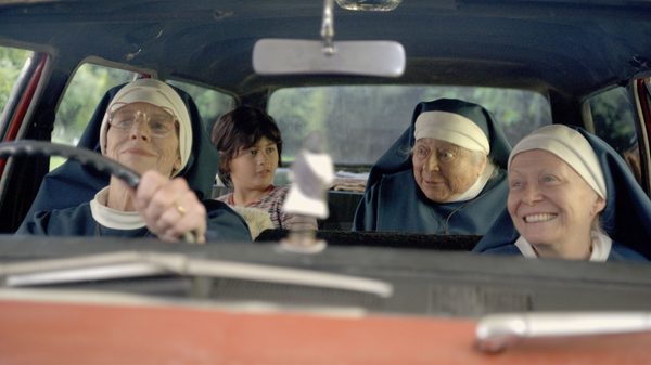 Holy Days film image; three nuns in a car with a young boy