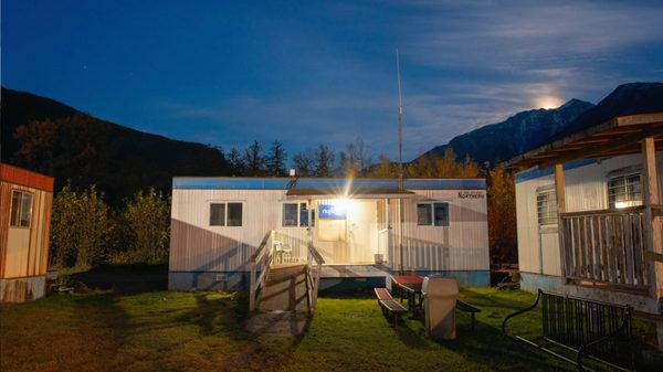 Nuxalk Radio film image; a small building in a forest