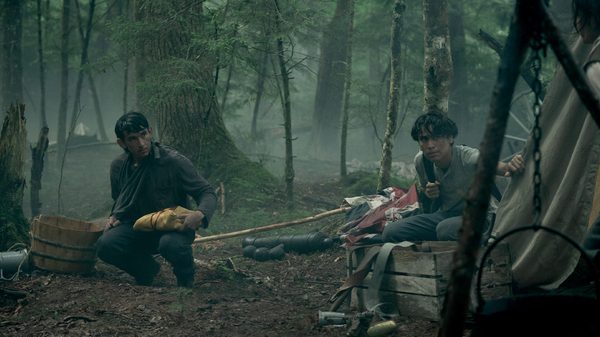 At the Place of Ghosts film image; two people in a misty forest camp