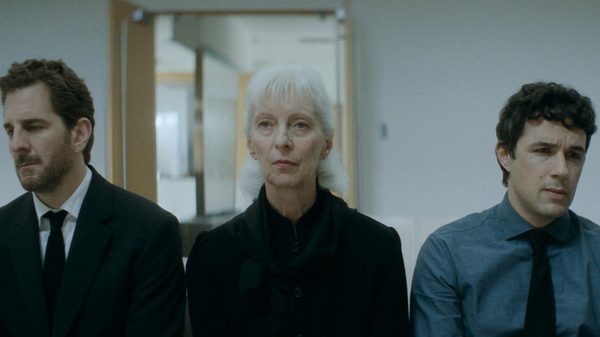 Best Boy film image; three people sitting shoulder to shoulder