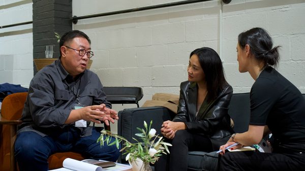 three people talking on couches