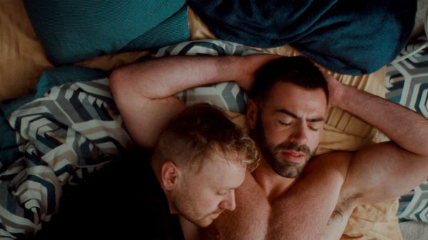 Departures film image; two people sleeping in a bed