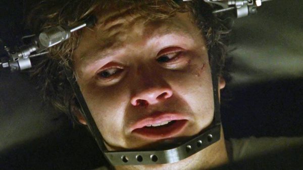 Jacob's Ladder film image; upset man with a contraption secured around his head