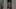Lacombe, Lucien film image; person looking through a partially opened door
