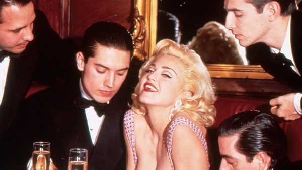 Madonna: Truth or Dare film image; woman posing for a photo next to a man looking down