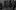 Schindler's List film mage; girl in a red coat walking amongst adults in black and white