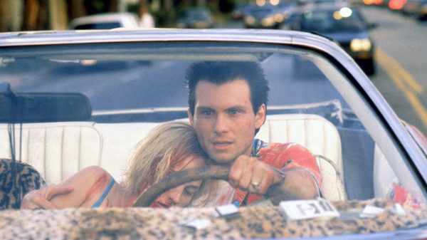 True Romance film image; woman leaning against a man while he drives a convertible car