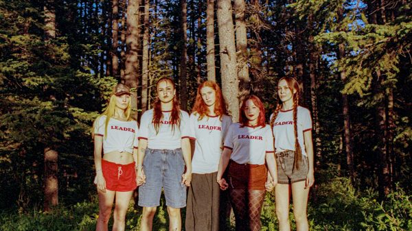 Camp film image; teen girls posing for a photo in the woods