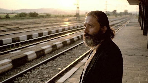 Glory film image; man standing by train tracks