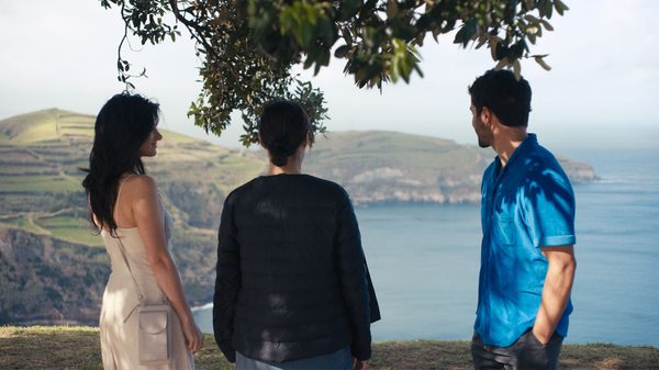 Honeyjoon film image; three people looking out at water from a hill