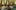 9 Temples to Heaven film image; people seated on the ground listening to a monk