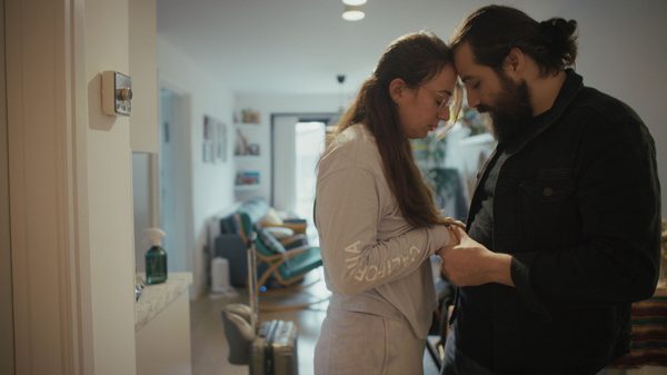 Birds of War film image; two people with their foreheads pressed together