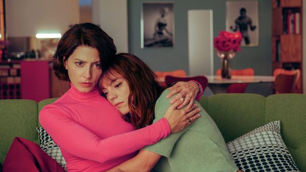 Bitter Christmas film image; two women hugging on a sofa