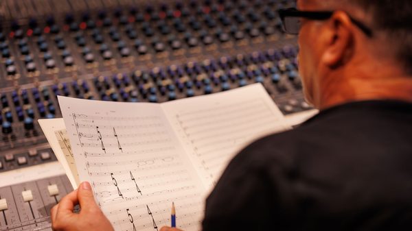 person looking at a music score