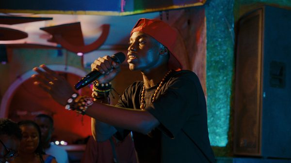 Congo Boy film image; man using a microphone