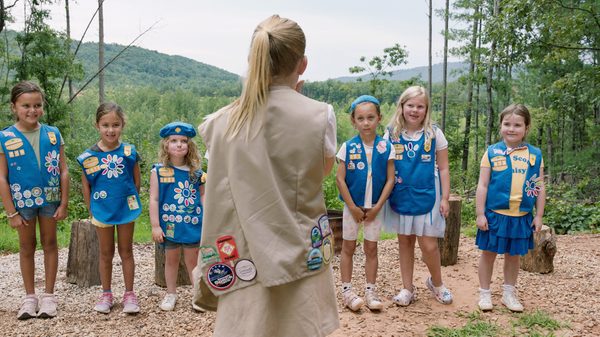 Cookie Queens film image; group of girls in front of camp leader