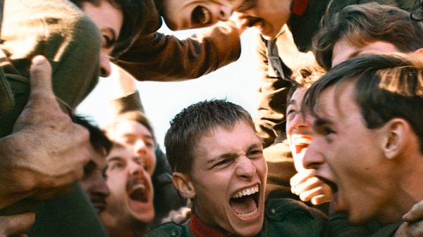 Coward film image; men huddled together and screaming