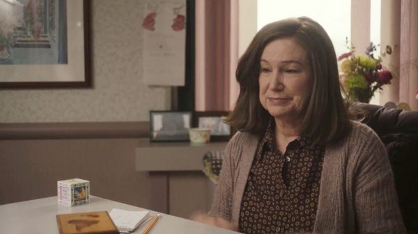 Diane film image; woman sitting at a table