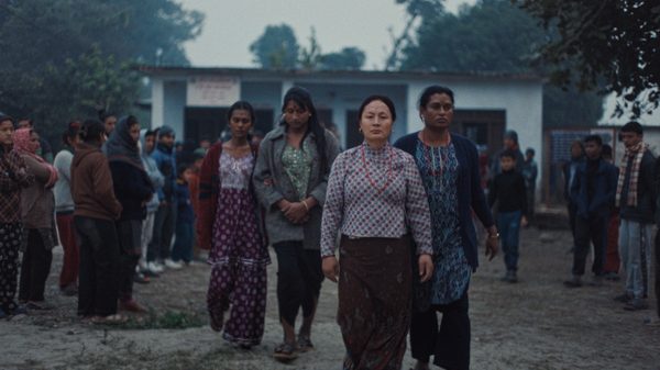 Elephants in the Fog film image; four women walking away from a building