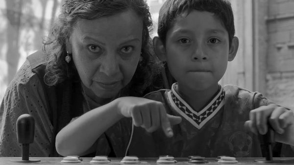 Flies film image; woman hovering behind a young boy
