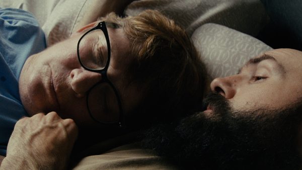 Going Nowhere Fast film image; two people lying in a bed
