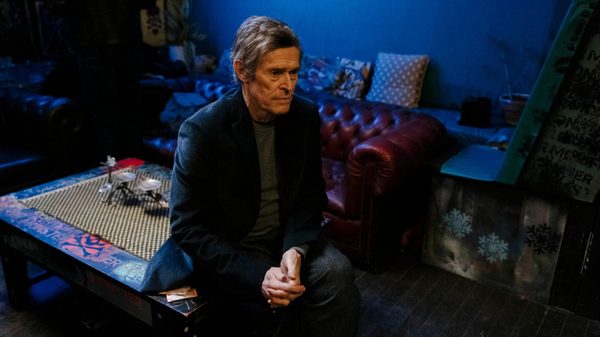 Late Fame film image; man sitting on a coffee table despondently