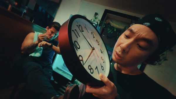 Midnight Momo film image; man examining a clock