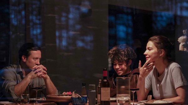 Minotaur film image; people laughing around a dinner table