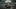 Paris Paris film image; two people sitting on the ground in a deserted city square
