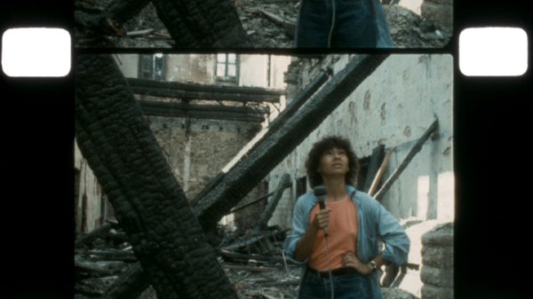Revolutionaries Never Die film image; person walking through collapsed building