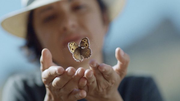 Searching for Satyrus film image; lady holding butterfly