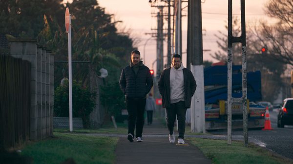 Tenor: My Name Is Pati film image; two men walking on a sidewalk