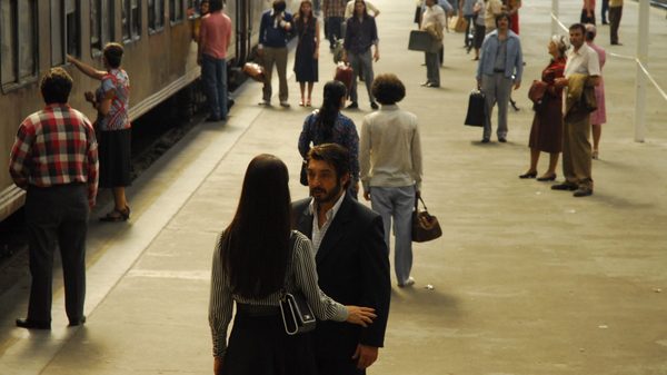 The Secrets in Their Eyes film image; two people talking in a crowded train station