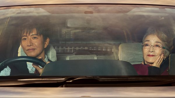 Tokyo Taxi film image; two people in the front seat of a car