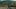 Whispers in May film image; children walking on pavement with a mountain in the distance