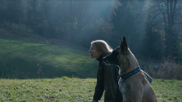 The Animal Remains film image; woman and a dog looking at something offscreen