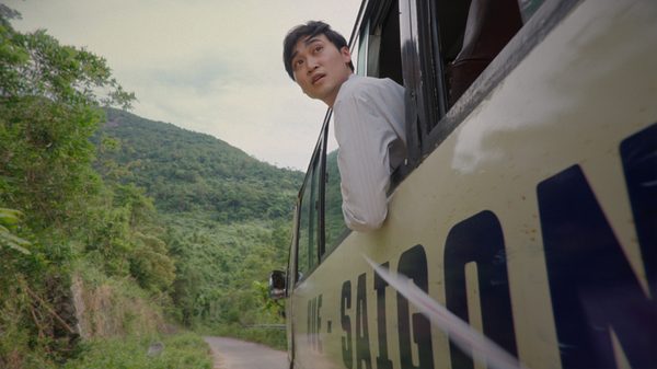Ba's Book film image; man leaning out of a bus window
