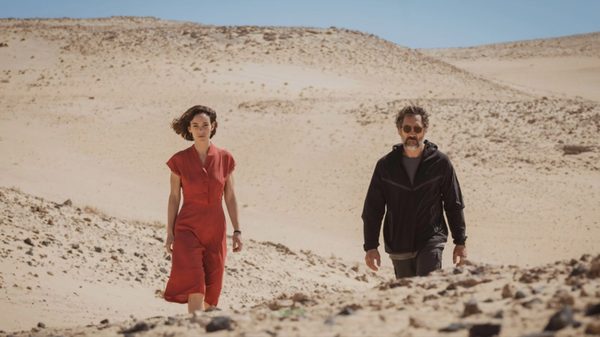 The Beloved film image; two people walking through the desert