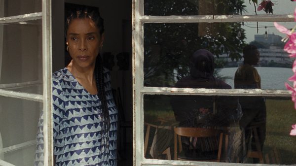 Clarissa film image; a woman peering out an open door