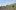 Concrete Land film image; person sitting on a grassy hill